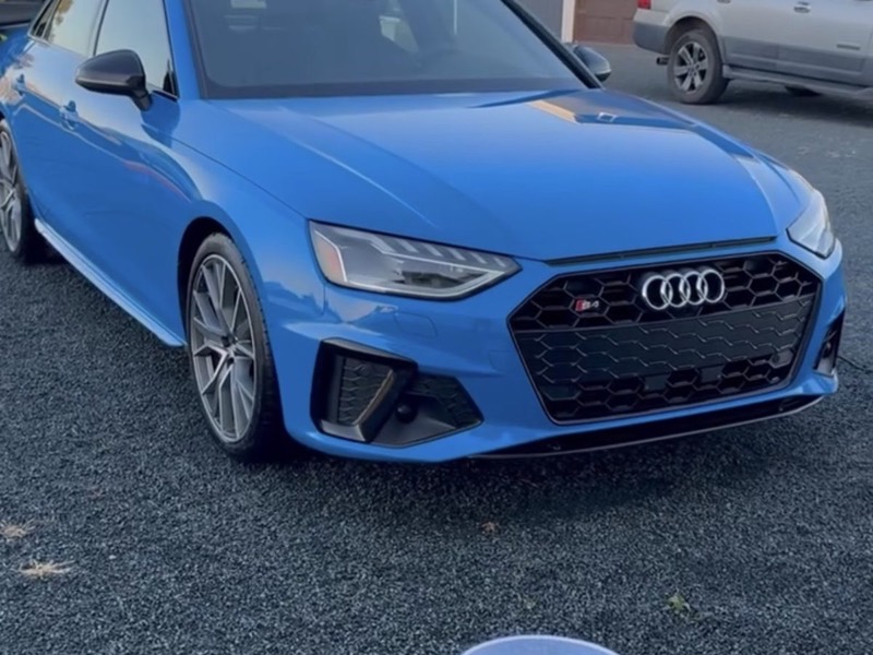 Blue Audi S4 headlight and grille after a detail